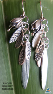 Springs Promise Gold and Silver Earrings, shown on a harakeke leaf by jewellery nz designer Martyn Milligan  