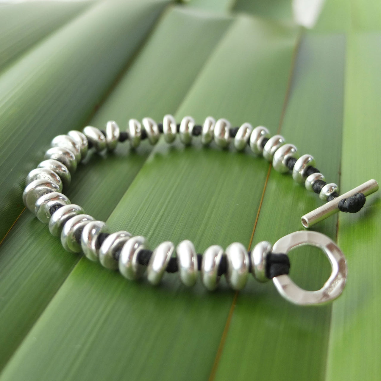 Rinopai handmade silver bead bracelet on black woven thread
