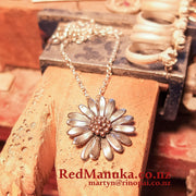 Jewellery NZ | Daisy Necklace | Redmanuka with chain on bench peg