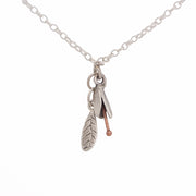 SIlver Bud and Leaf necklace. Small flower hangs over a silver leaf, by NZ jeweller Martyn Milligan, Rinopai, Golden Bay , Nelson.
